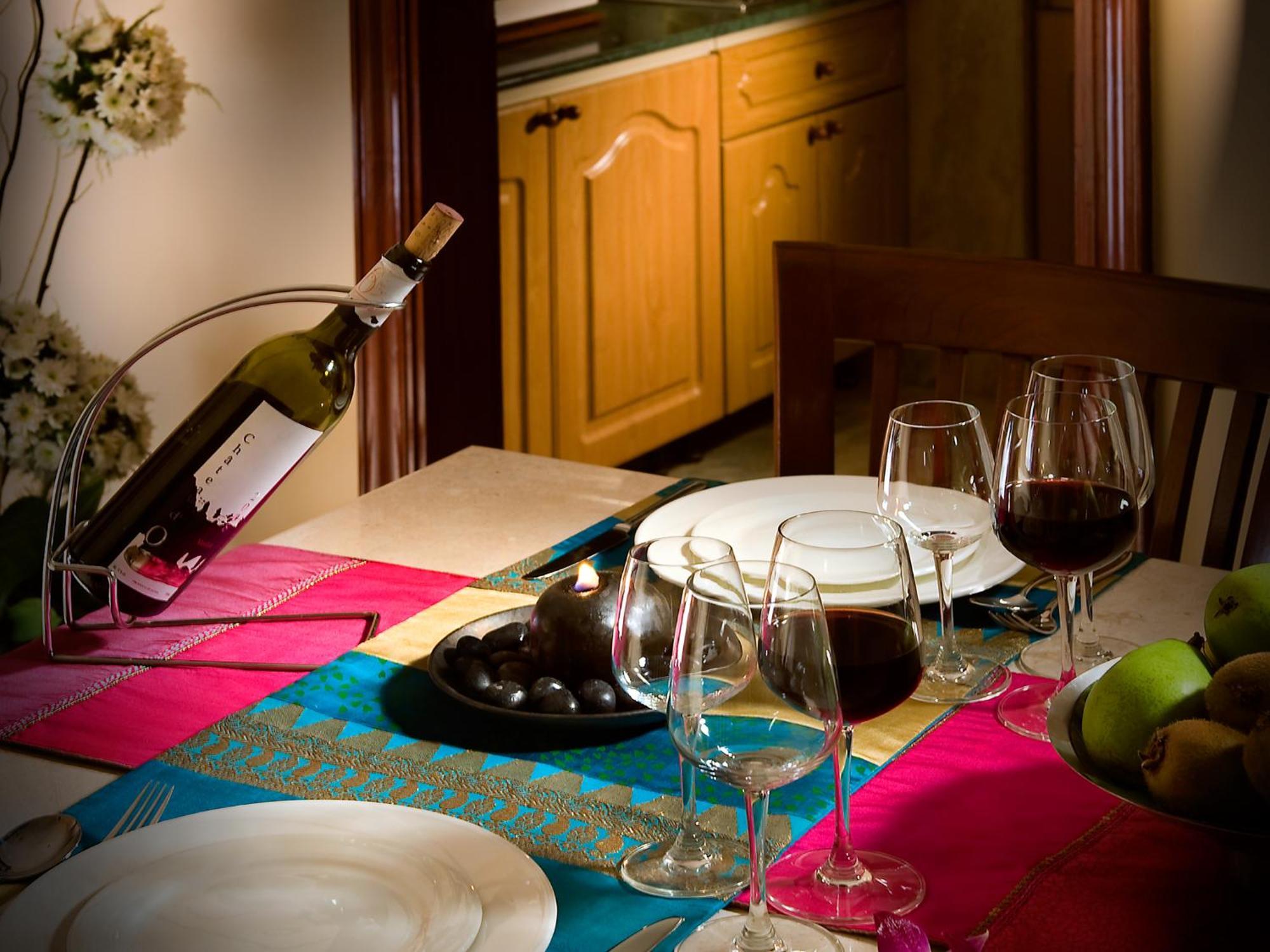 The Lalit Mumbai Hotel Bagian luar foto A wine bottle and glasses